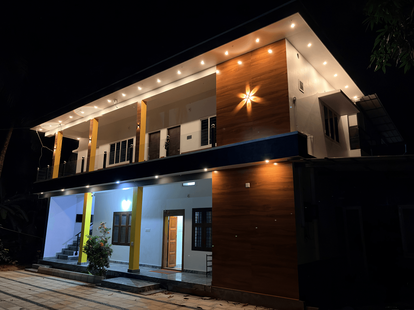 Arena Gardens farm stay exterior in Sreekrishnapuram near Ottapalam, Kerala, at night with warm ambient lighting